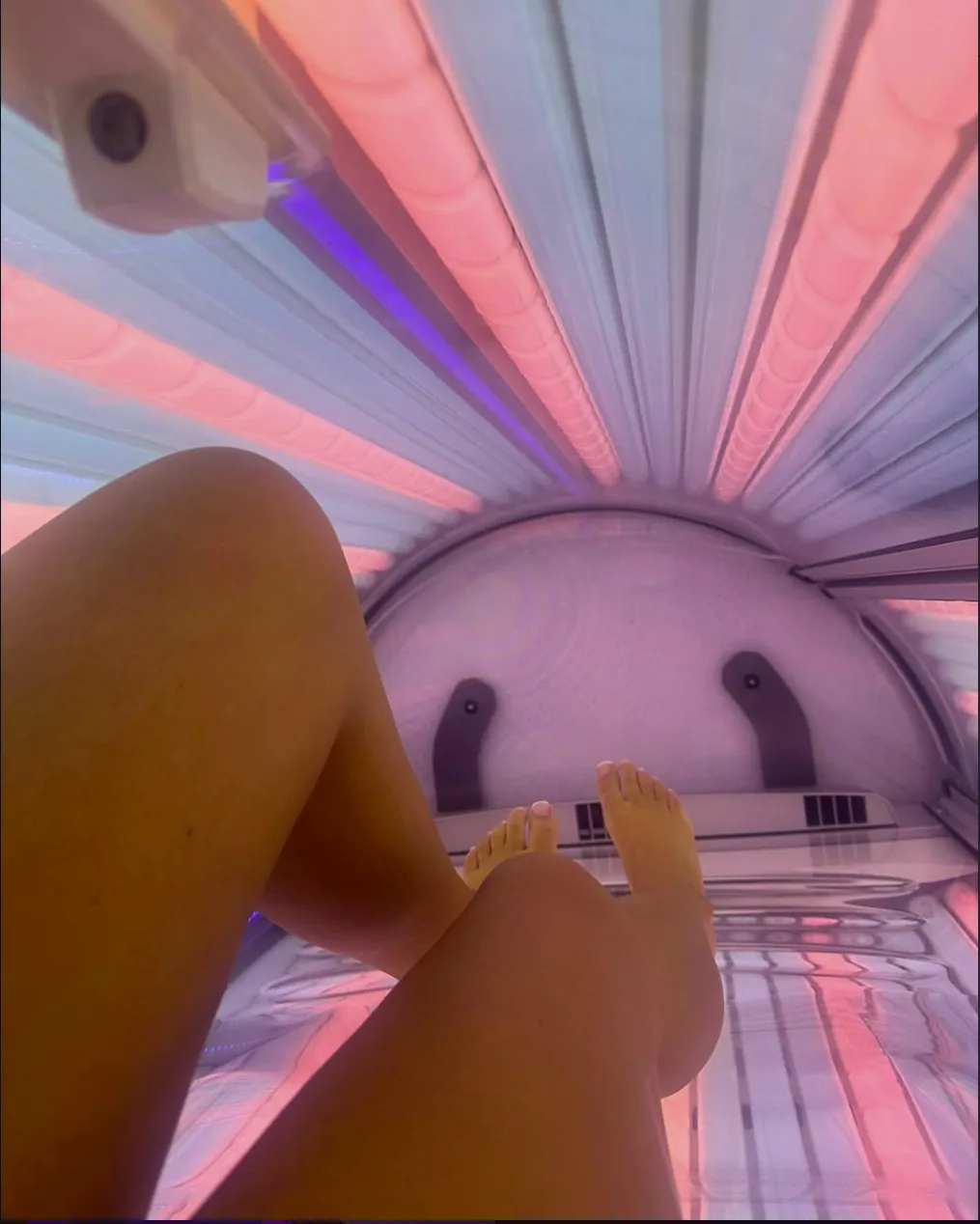 Inside a Luxura stand-up booth, pink and amber glow